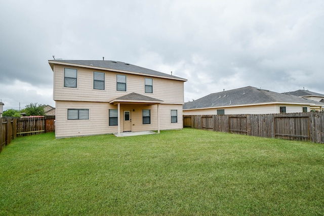 rear view of house with a yard