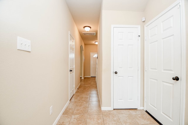 corridor with light tile patterned floors