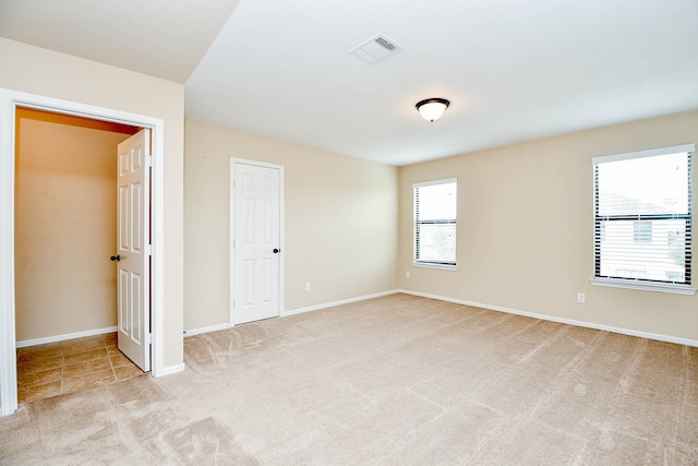 unfurnished bedroom featuring light colored carpet