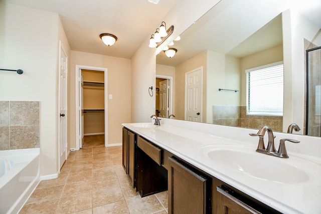 bathroom with vanity, tile patterned floors, and plus walk in shower