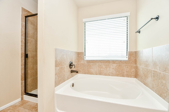 bathroom with tile patterned flooring and shower with separate bathtub