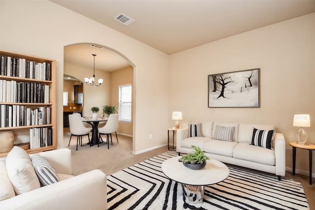 living room featuring a notable chandelier and carpet floors