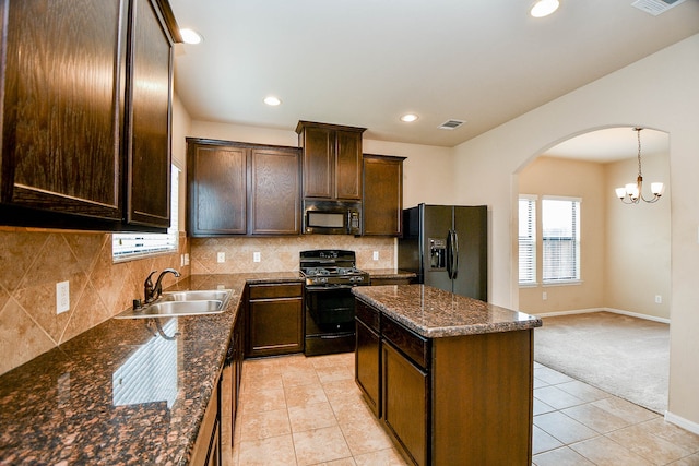 kitchen featuring a chandelier, black appliances, sink, decorative backsplash, and light colored carpet