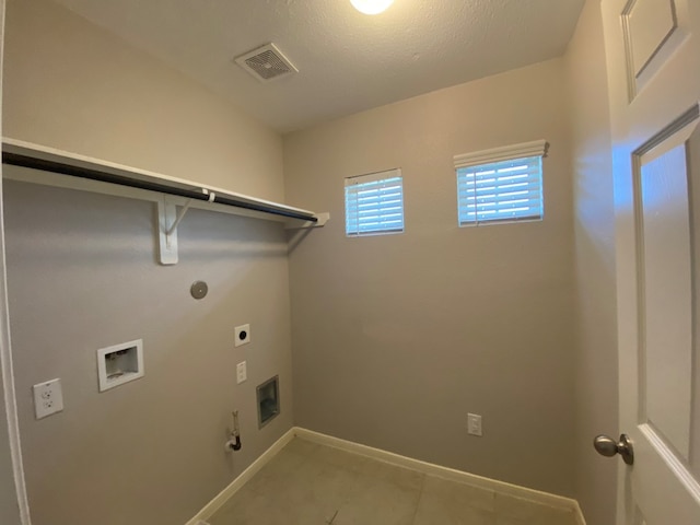 laundry room featuring washer hookup, a textured ceiling, electric dryer hookup, hookup for a gas dryer, and light tile patterned flooring