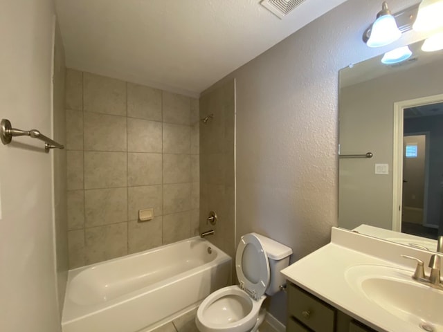 full bathroom featuring vanity, toilet, and tiled shower / bath