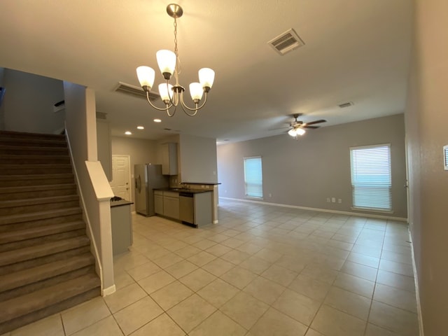 unfurnished living room featuring ceiling fan with notable chandelier and light tile patterned flooring