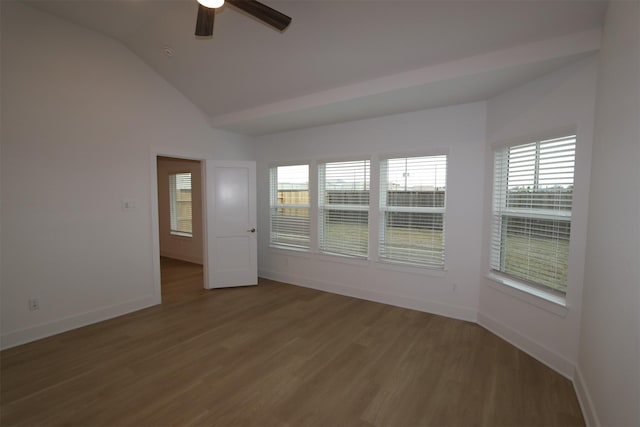 spare room with hardwood / wood-style flooring, lofted ceiling, and ceiling fan