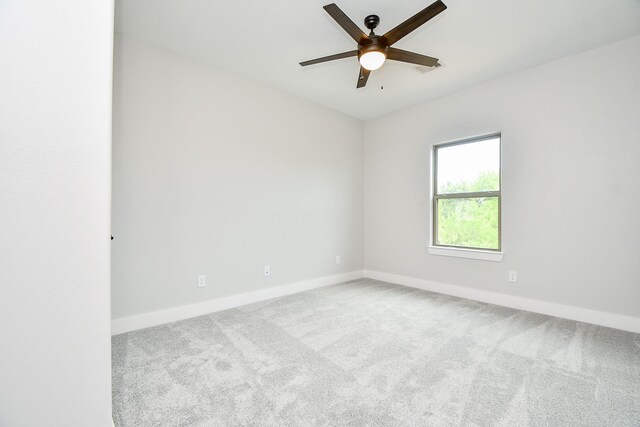 spare room featuring ceiling fan and carpet flooring