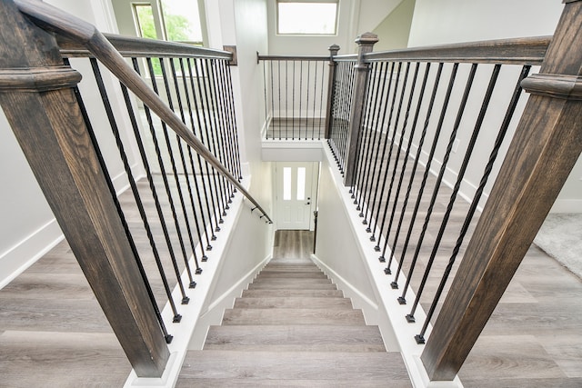 staircase with hardwood / wood-style floors