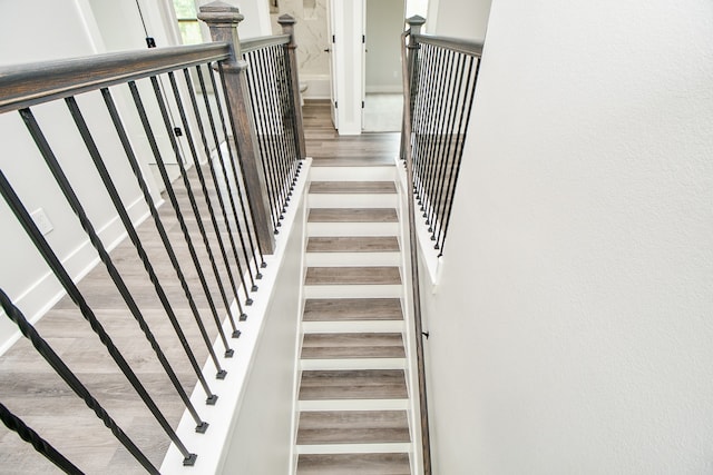 stairway featuring hardwood / wood-style floors