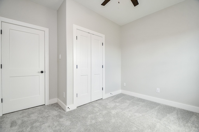 unfurnished bedroom with a closet, ceiling fan, and light colored carpet