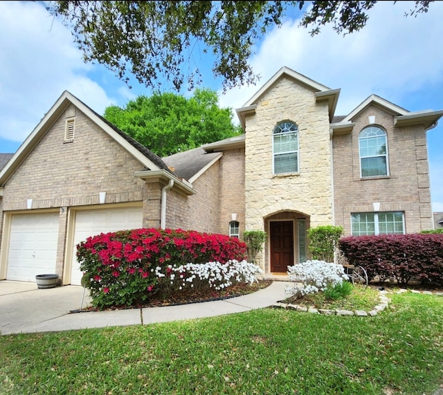 front of property with a front yard and a garage