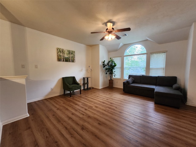 living room with dark wood-type flooring and ceiling fan