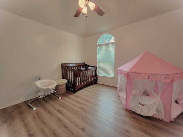 bedroom featuring hardwood / wood-style floors, ceiling fan, and vaulted ceiling