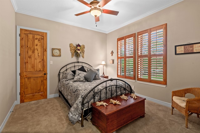 carpeted bedroom featuring ceiling fan and ornamental molding