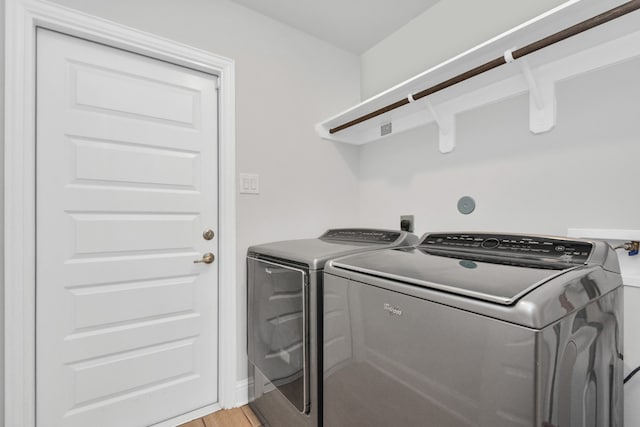 laundry room featuring light wood-type flooring and washer and dryer