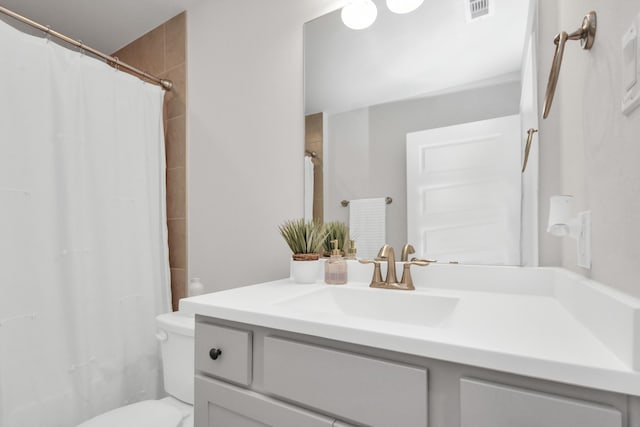 bathroom featuring toilet, a shower with curtain, and vanity