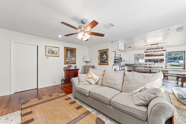 living room with hardwood / wood-style floors and ceiling fan