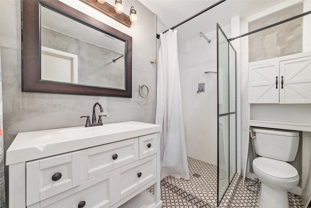 bathroom with tile patterned floors, vanity, toilet, and walk in shower