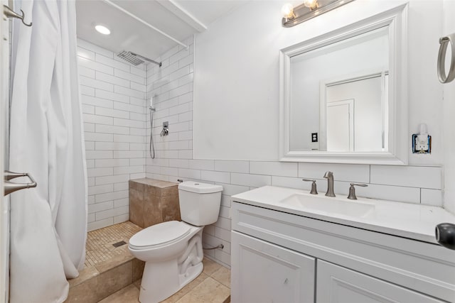 bathroom featuring tile patterned floors, vanity, tile walls, toilet, and curtained shower