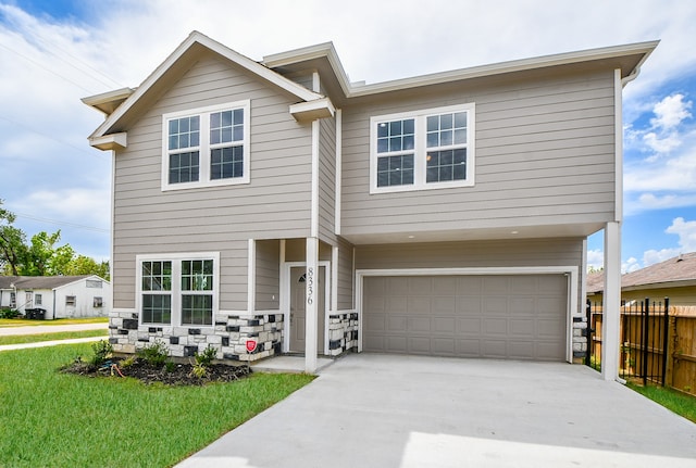 view of front of property with a garage and a front lawn