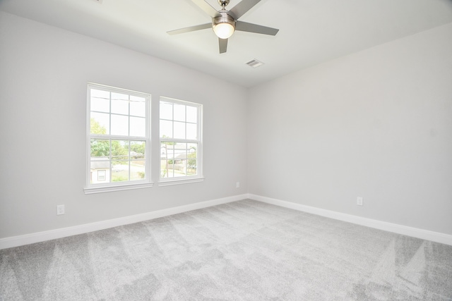 spare room featuring ceiling fan and carpet floors