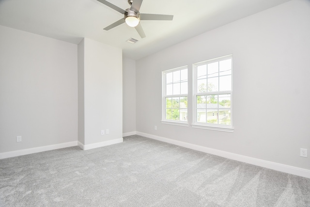 carpeted spare room featuring ceiling fan