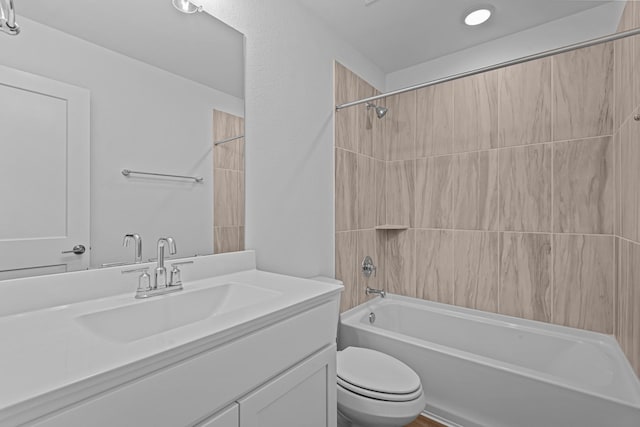 full bathroom featuring vanity, bathtub / shower combination, and toilet