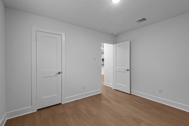 unfurnished bedroom with light wood-type flooring