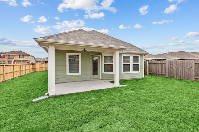 rear view of house with a patio and a lawn