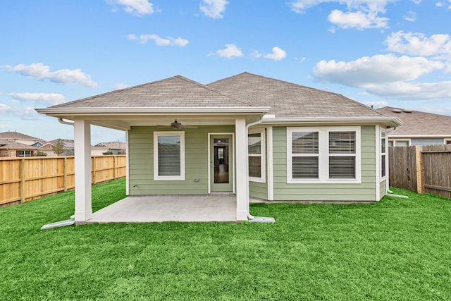 back of house featuring ceiling fan, a yard, and a patio