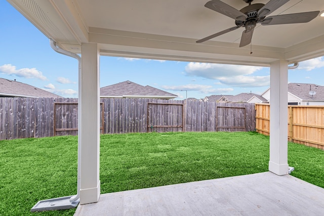 view of yard featuring ceiling fan and a patio