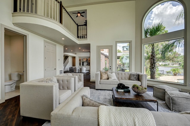 living room with a high ceiling and wood-type flooring