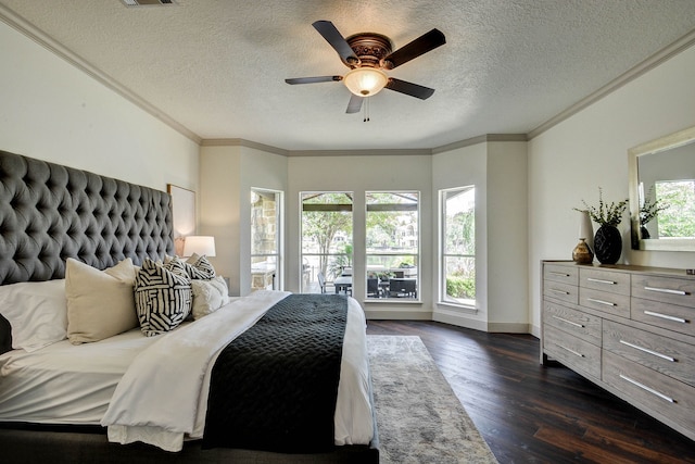 bedroom featuring multiple windows, ceiling fan, dark hardwood / wood-style flooring, and a textured ceiling