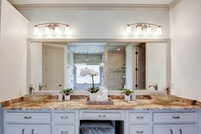 bathroom with vanity, ornamental molding, and a shower with shower door