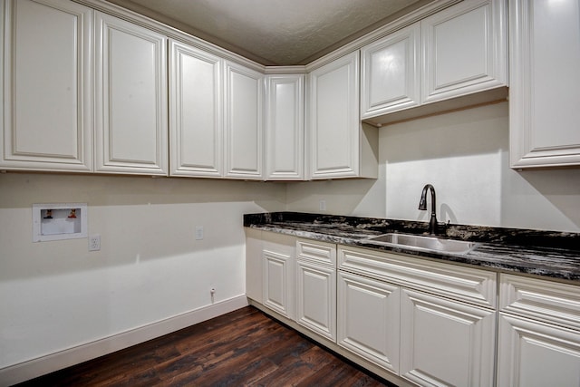 kitchen with dark stone countertops, dark hardwood / wood-style flooring, white cabinetry, sink, and a textured ceiling