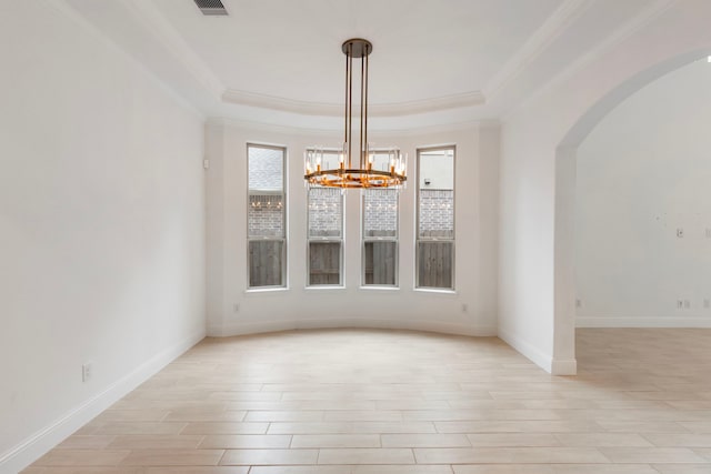 unfurnished dining area featuring ornamental molding, a chandelier, and light hardwood / wood-style floors