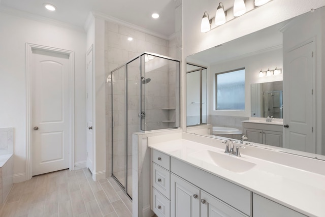 bathroom featuring vanity, ornamental molding, and plus walk in shower