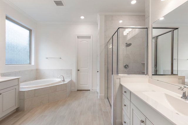 bathroom with vanity, hardwood / wood-style floors, ornamental molding, and independent shower and bath