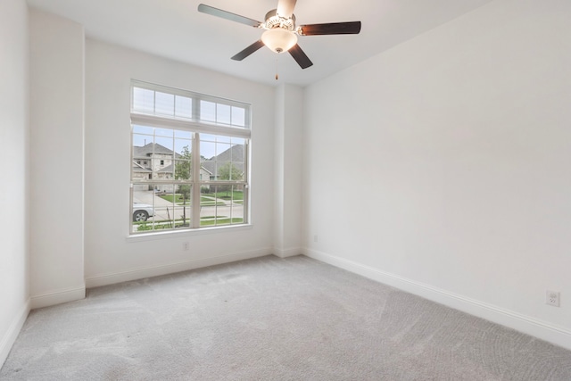 unfurnished room featuring ceiling fan and light carpet