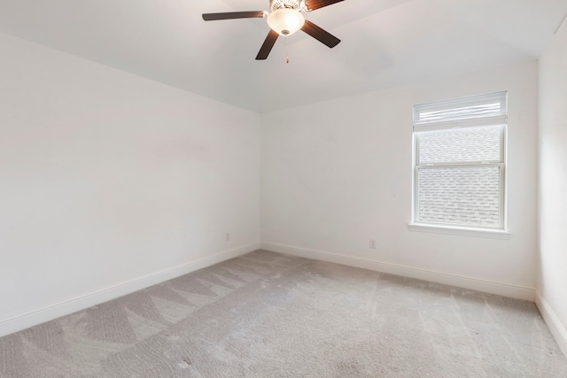 spare room with lofted ceiling, light colored carpet, and ceiling fan