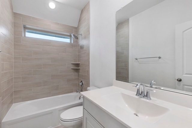 full bathroom featuring tiled shower / bath, vanity, and toilet