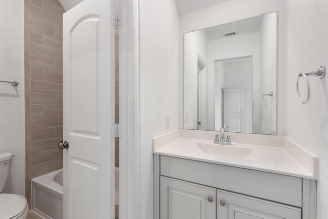 bathroom featuring vanity and toilet