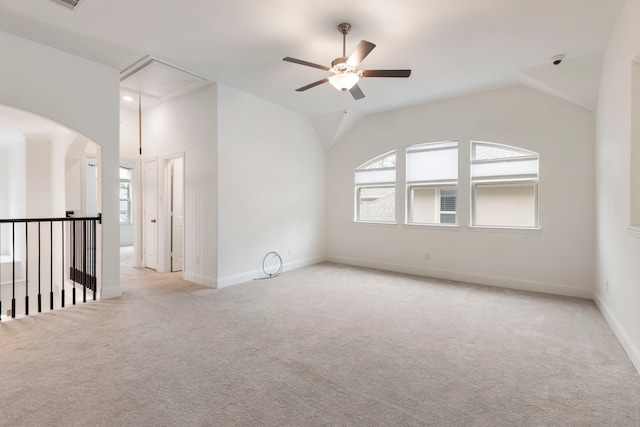 unfurnished room with ceiling fan, light carpet, and vaulted ceiling