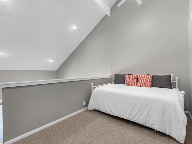 carpeted bedroom with ceiling fan and vaulted ceiling with beams