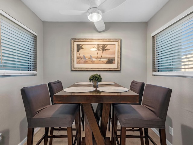 dining area featuring tile patterned floors, ceiling fan, and baseboards