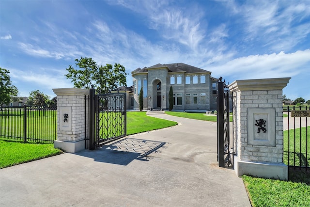 view of gate with a lawn