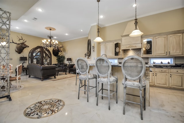 kitchen with hanging light fixtures, light brown cabinets, an inviting chandelier, and a breakfast bar