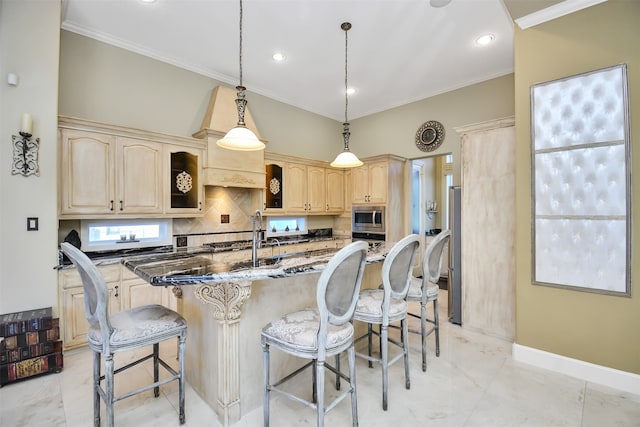 kitchen featuring dark stone counters, hanging light fixtures, ornamental molding, a breakfast bar, and stainless steel microwave