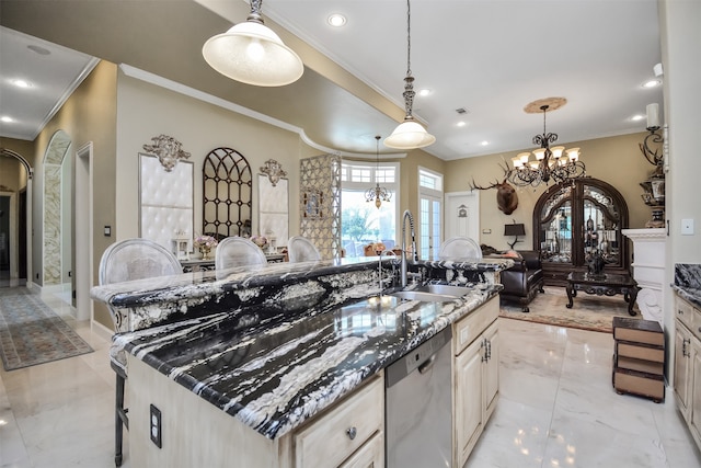 kitchen featuring dark stone counters, crown molding, dishwasher, sink, and a center island with sink